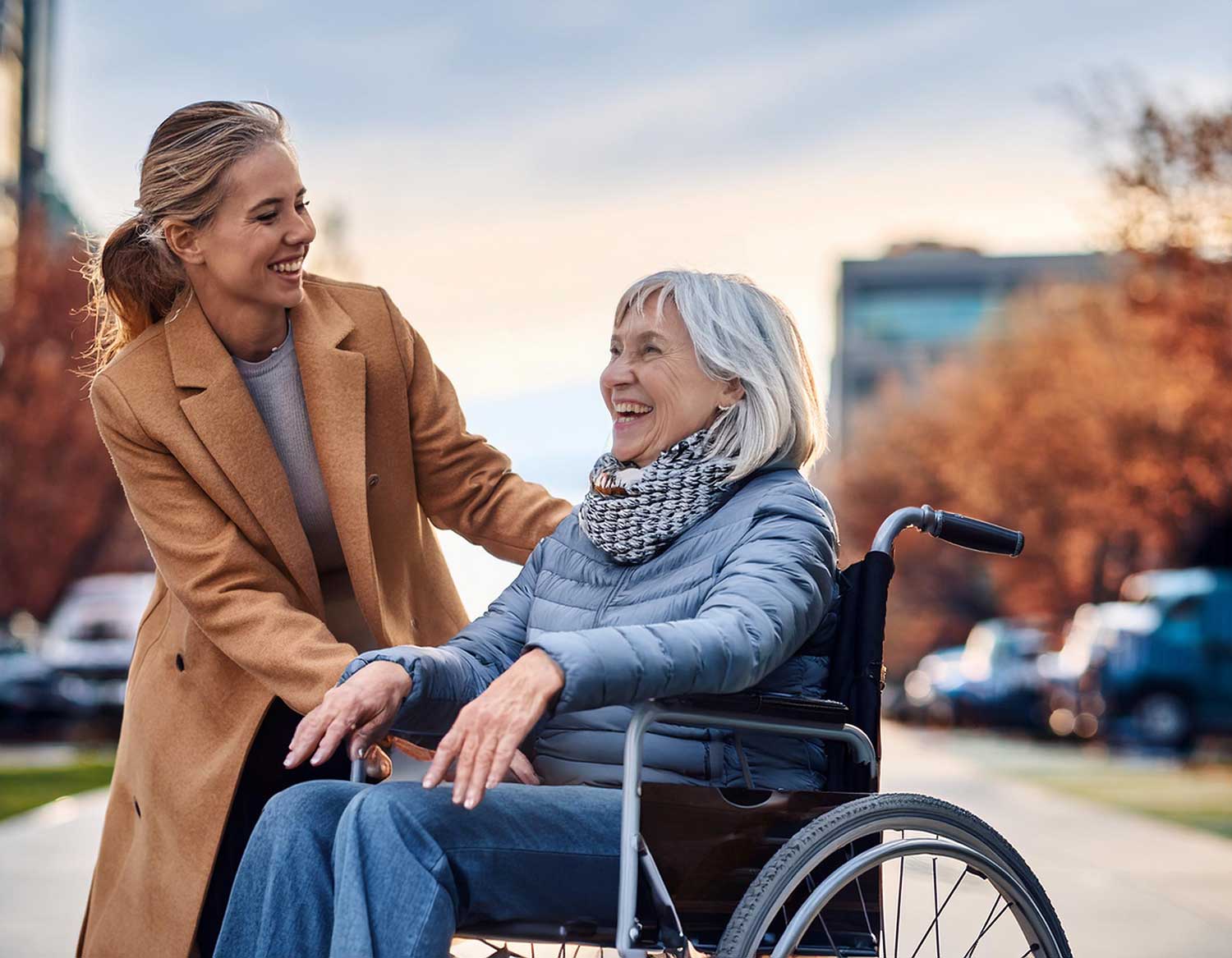 An adult daughter helps her mother in a wheelchair in Camby, IN